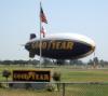 Your basic blimp, waiting for you in Carson, California (with flags)