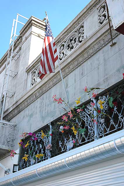 Storefront with flag and flowers, Wilcox Avenue at Hollywood Boulevard, 2 March 2006, noon