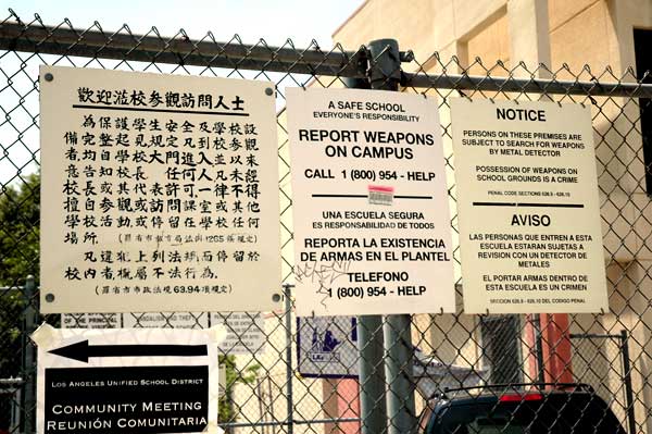 Signs on the fence at the elementary school on College Avenue, Los Angeles' Chinatown