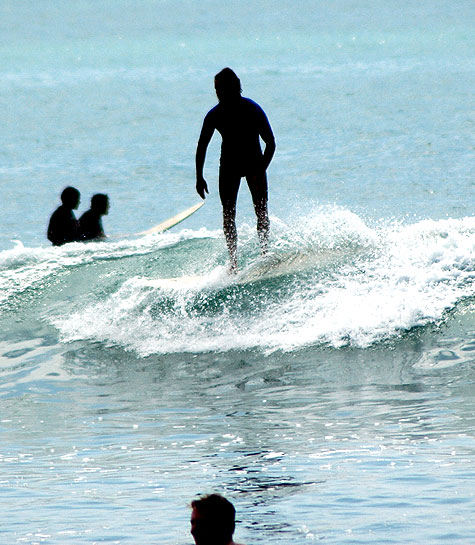 Backlit surfers, Surfrider Beach on the north side of Malibu Pier