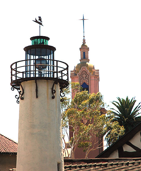 As seen from the rear, the steeple at The Church of the Blessed Sacrament(6657 Sunset Boulevard - Beezer Brothers, architects, 1928) with the fake lighthouse of Crossroads of the World (6671 Sunset Boulevard - Robert V. Derrah)
